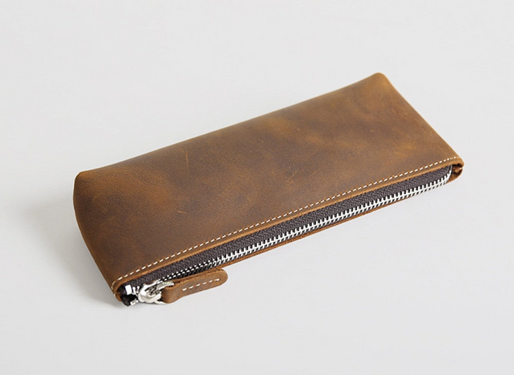 a brown leather case with zipper