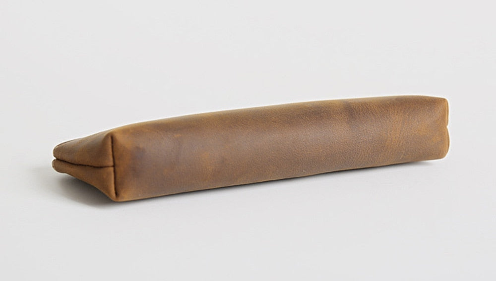 a brown leather case on a white surface
