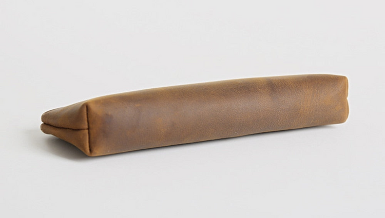 a brown leather case on a white surface