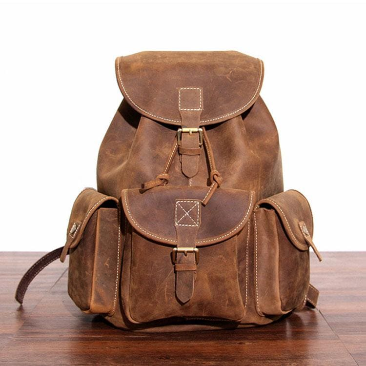 a brown backpack on a wood surface