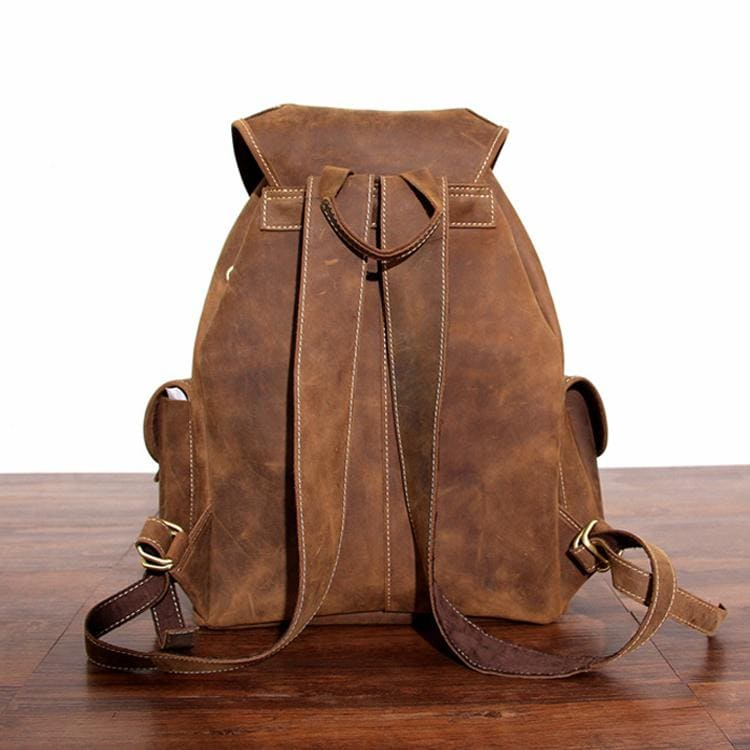 a brown backpack on a wood surface