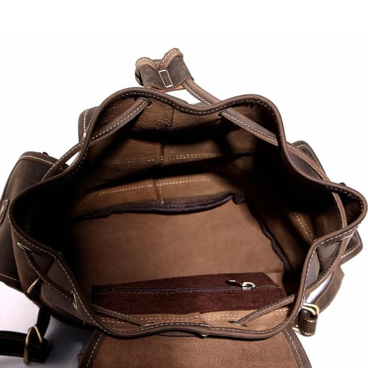 a brown leather backpack with a pocket