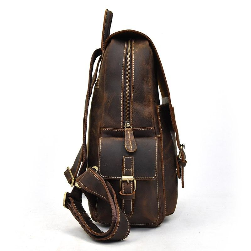 a brown leather backpack with a strap