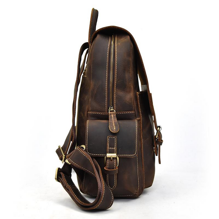 a brown leather backpack with a strap