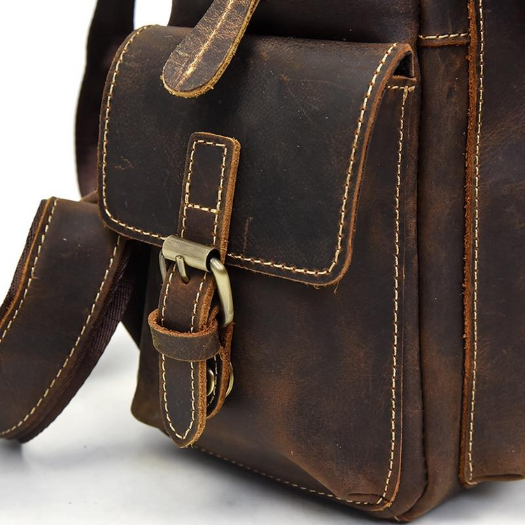 a brown leather bag with a buckle