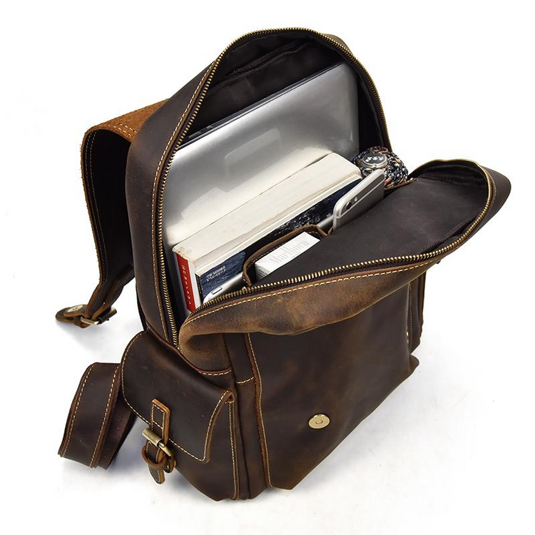 a brown backpack with a laptop and books inside