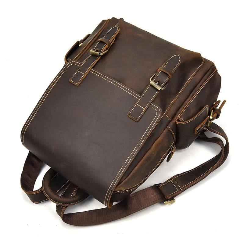 a brown leather bag with straps