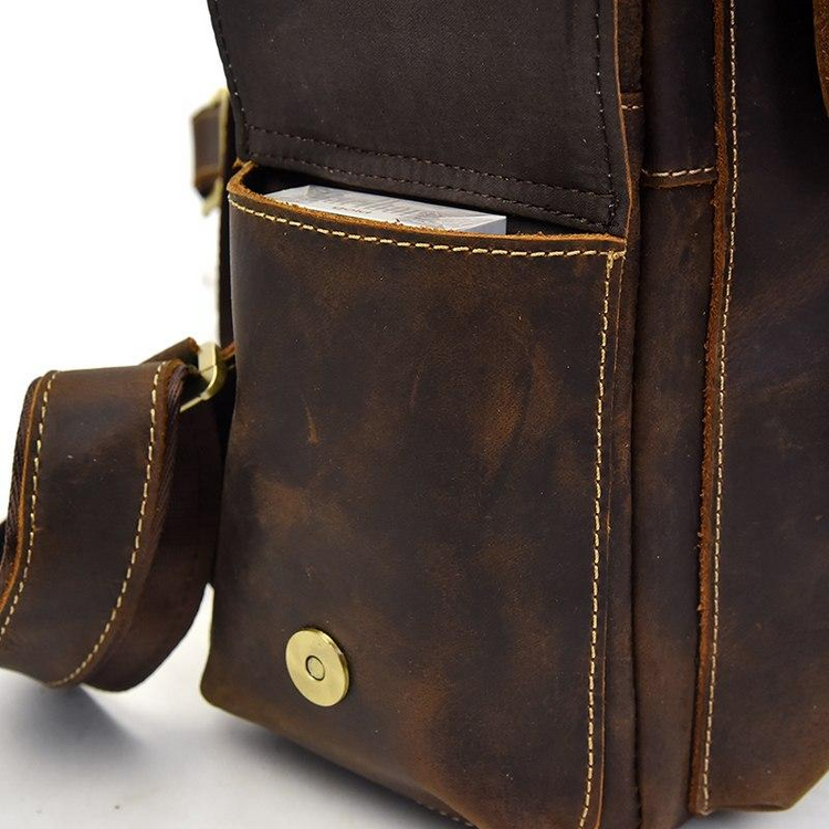 a brown leather bag with a pocket