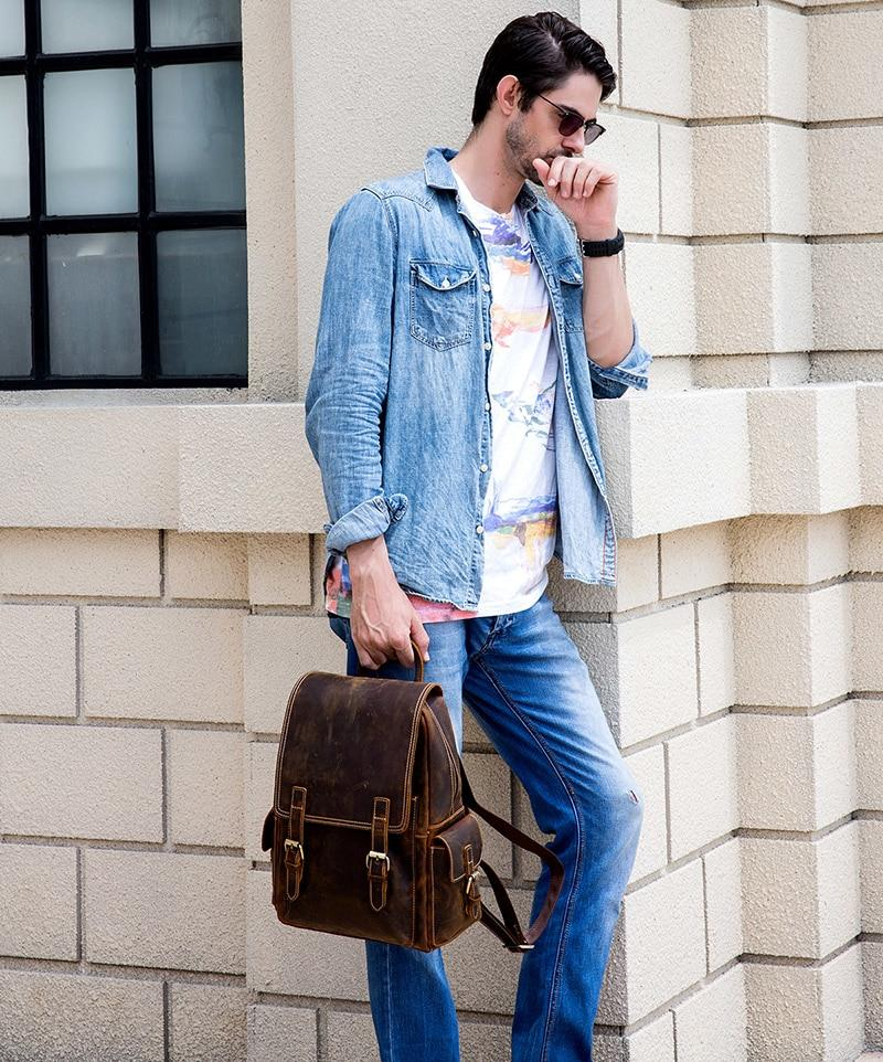a man wearing sunglasses and holding a brown bag