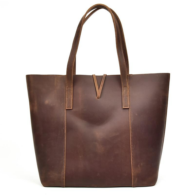 a brown leather bag with a v-shaped handle