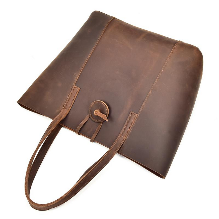 a brown leather bag with a button