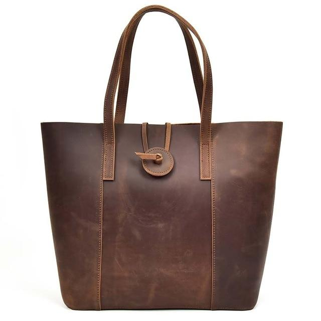 a brown leather bag with a handle