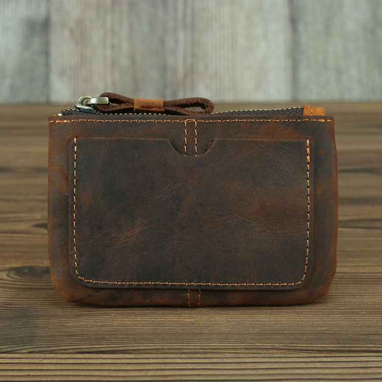a brown leather wallet on a wood surface
