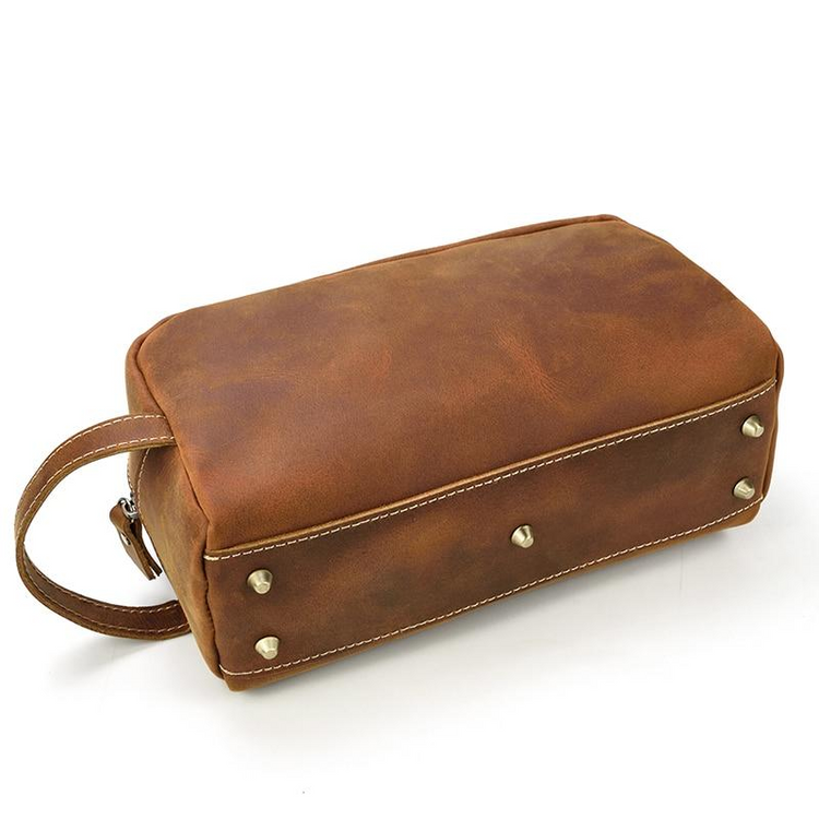 a brown bag with gold studs