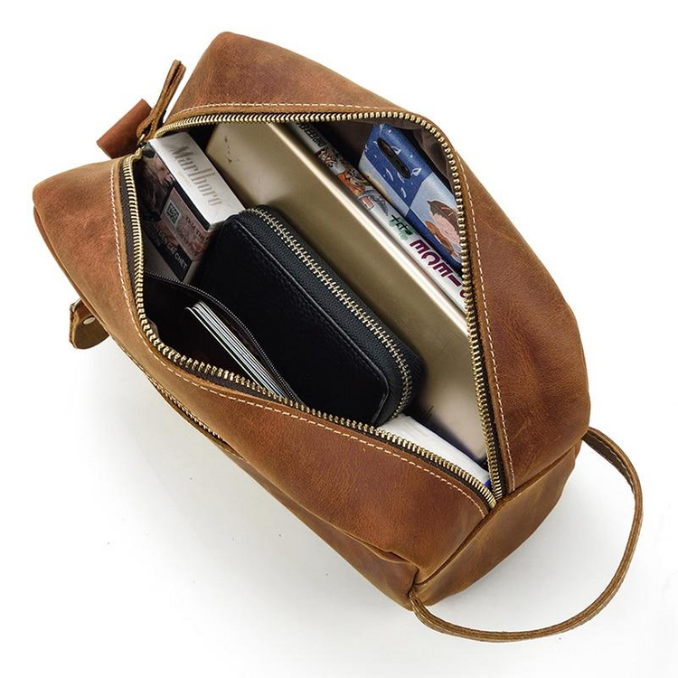a brown bag with a wallet and a phone inside
