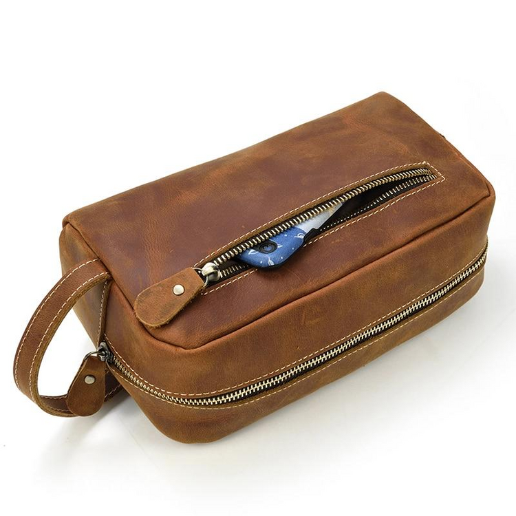 a brown leather bag with a zipper