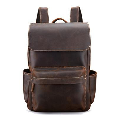 a brown leather backpack with pockets