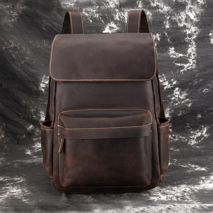 a brown backpack on a grey surface