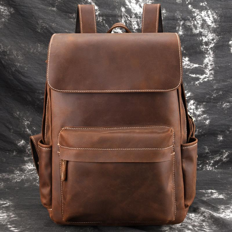 a brown backpack on a black surface