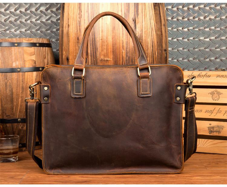a brown leather bag with a wooden barrel in the background