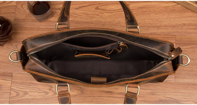 a brown leather purse on a wood surface