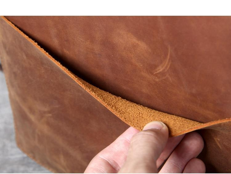 a person holding a piece of leather
