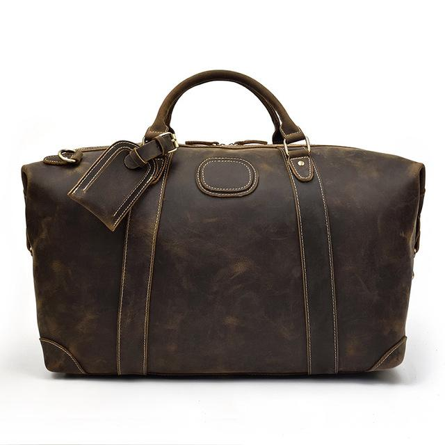 a brown leather bag with a tag