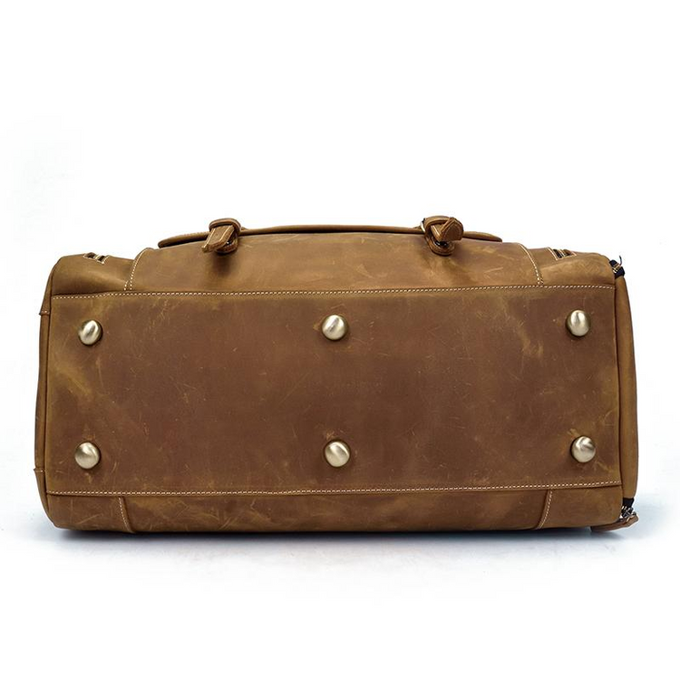 a brown leather bag with metal studs