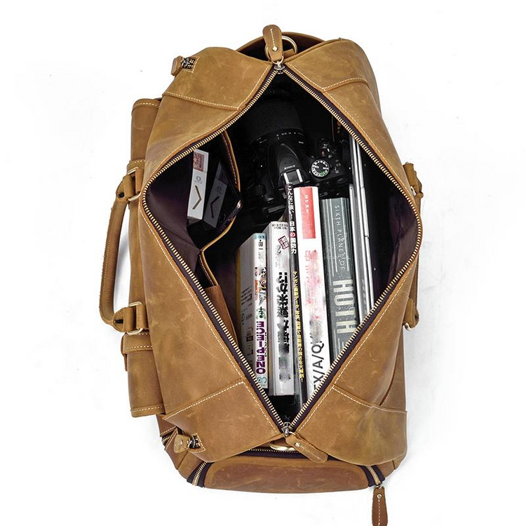 a brown bag with a camera and video cassettes inside
