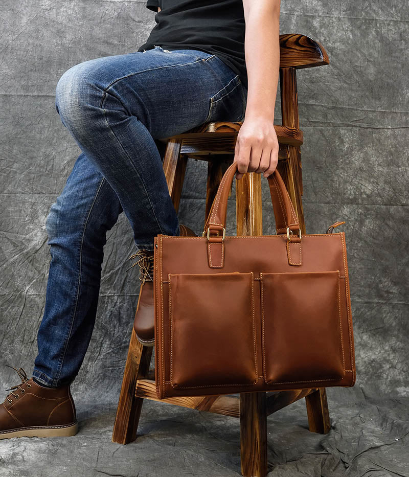 a person sitting on a stool holding a leather bag