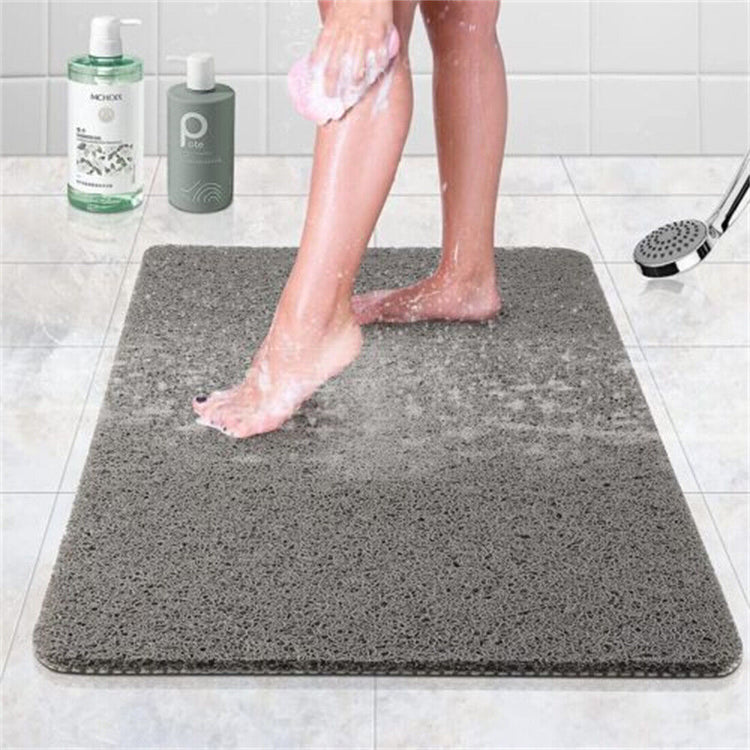 a person washing their legs on a grey rug with Hollywood Walk of Fame in the background