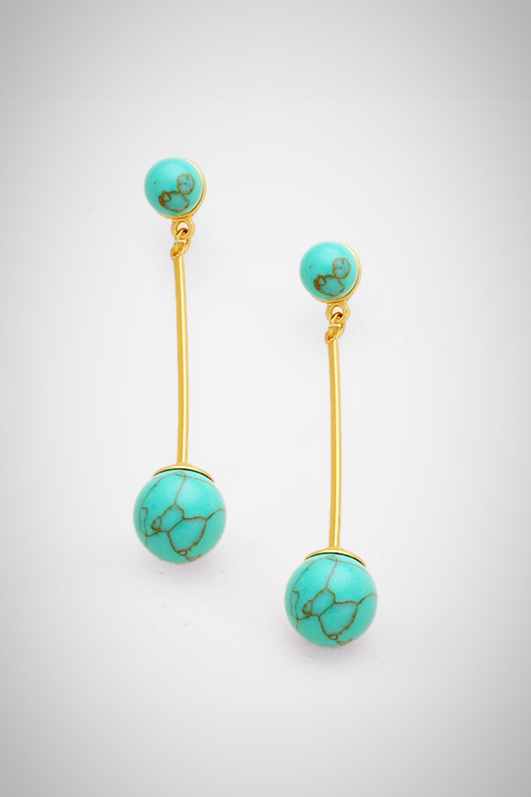 a pair of turquoise earrings