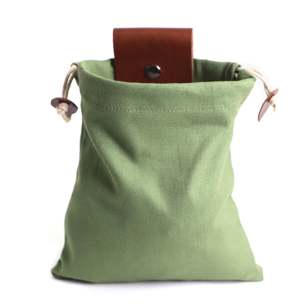 a green bag with a brown leather belt inside