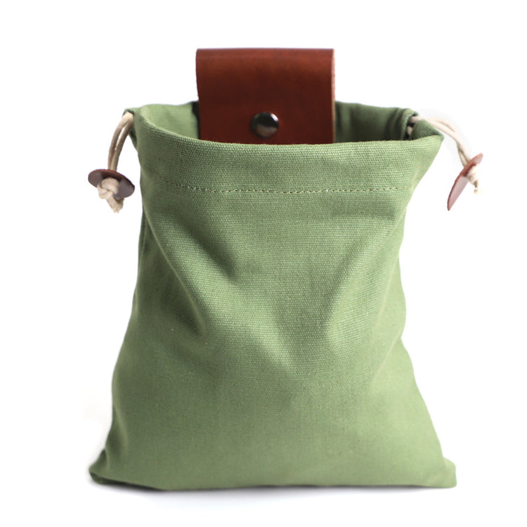 a green bag with a brown leather belt inside