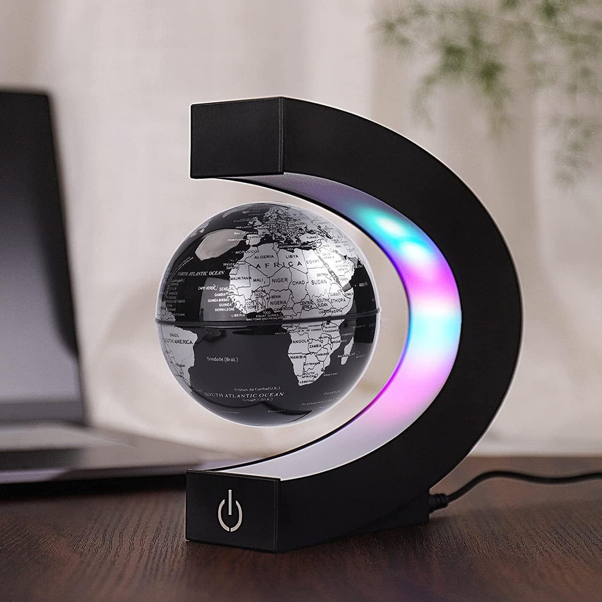 a black and colorful globe on a desk