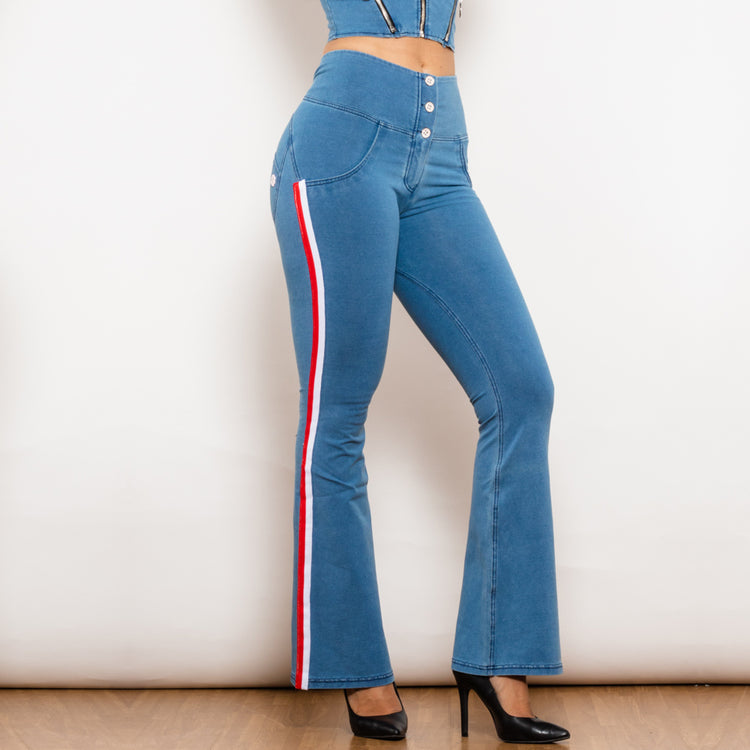 a woman wearing blue jeans and a crop top