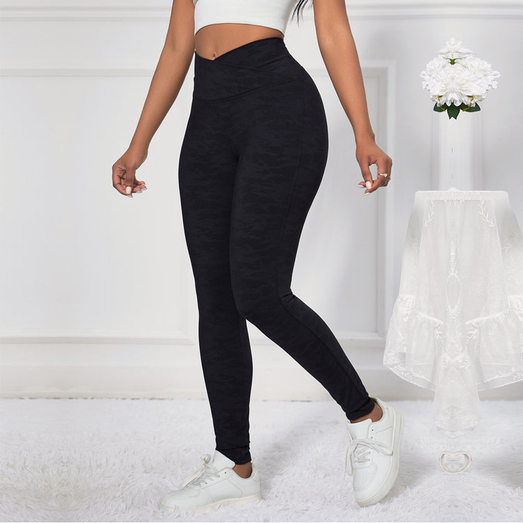 a woman wearing black leggings and white shoes