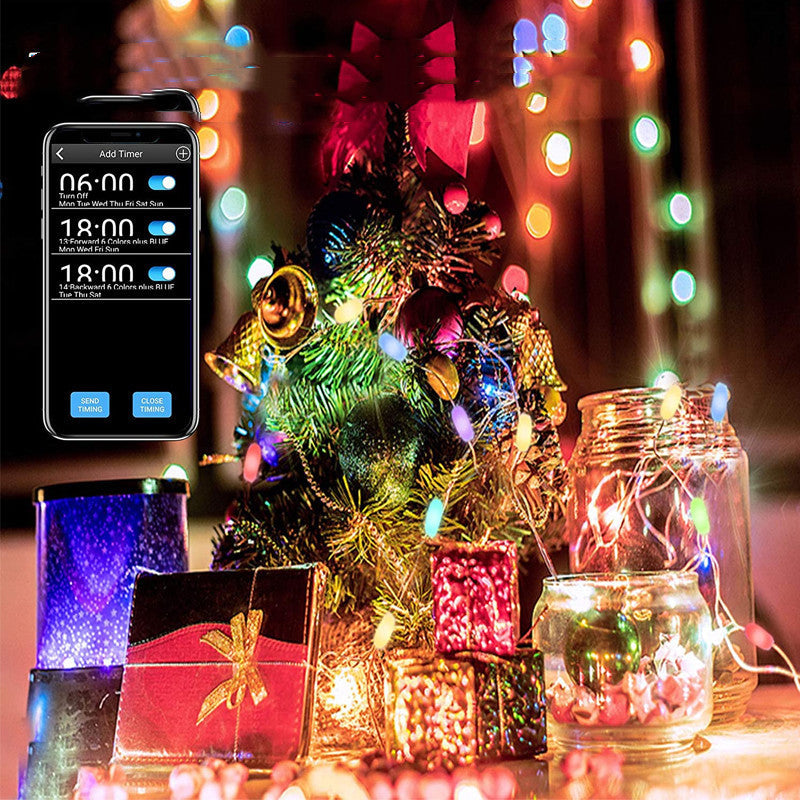 a christmas tree with lights and a phone