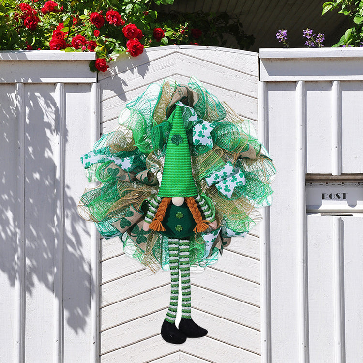 a green elf on a white gate
