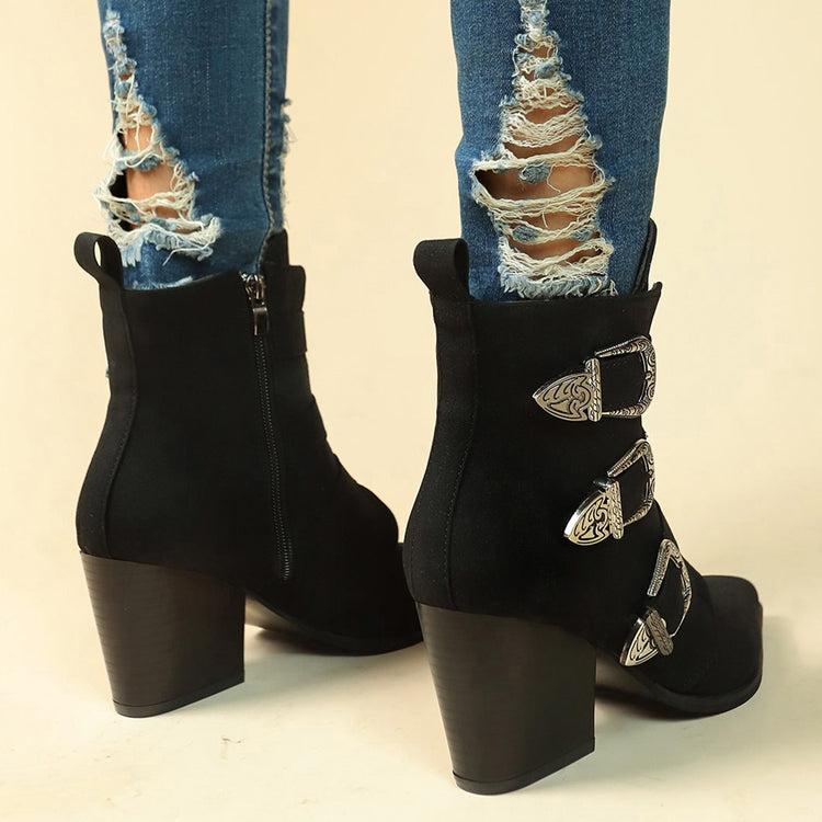 a person wearing ripped jeans and black boots