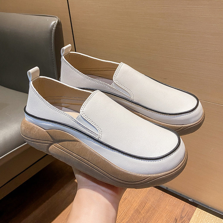 a person holding a pair of white shoes