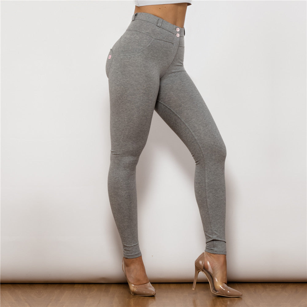 a woman wearing grey pants and heels