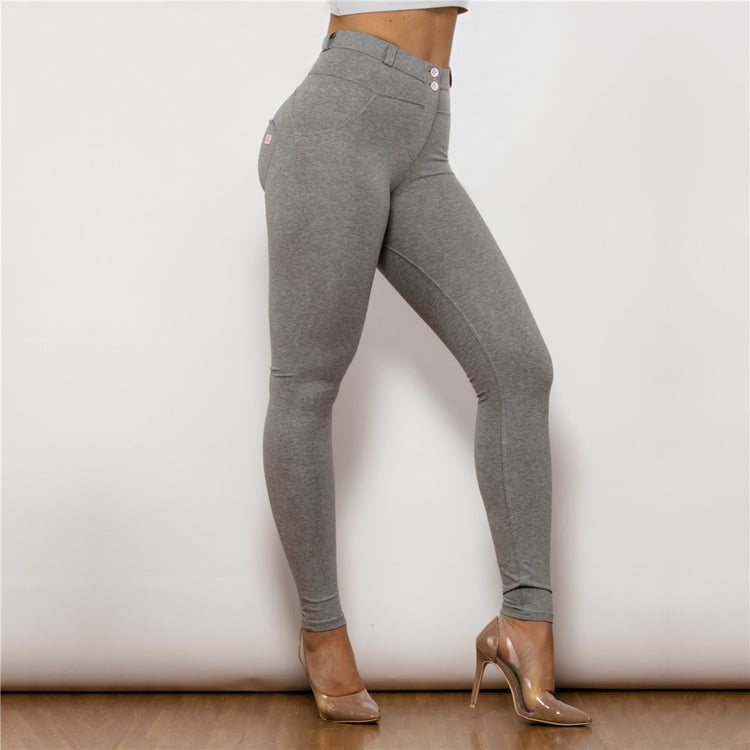 a woman wearing grey pants and heels
