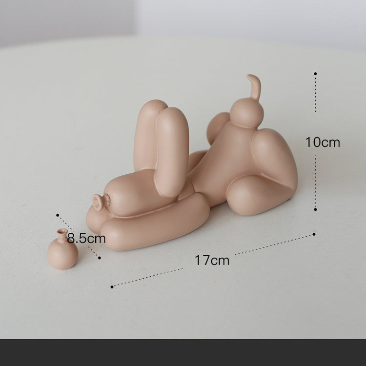 a small figurine of a person lying on a white surface