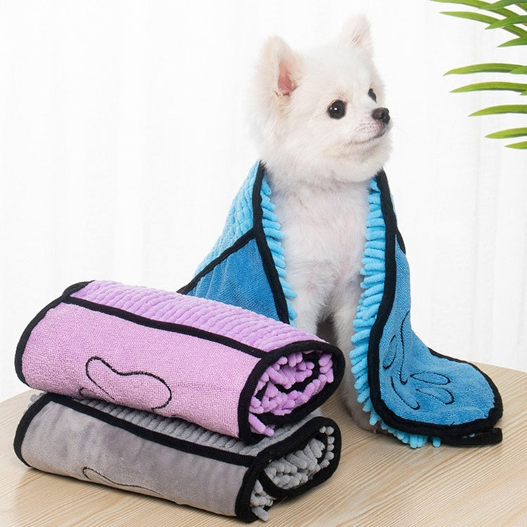 a dog sitting on a table with a blanket