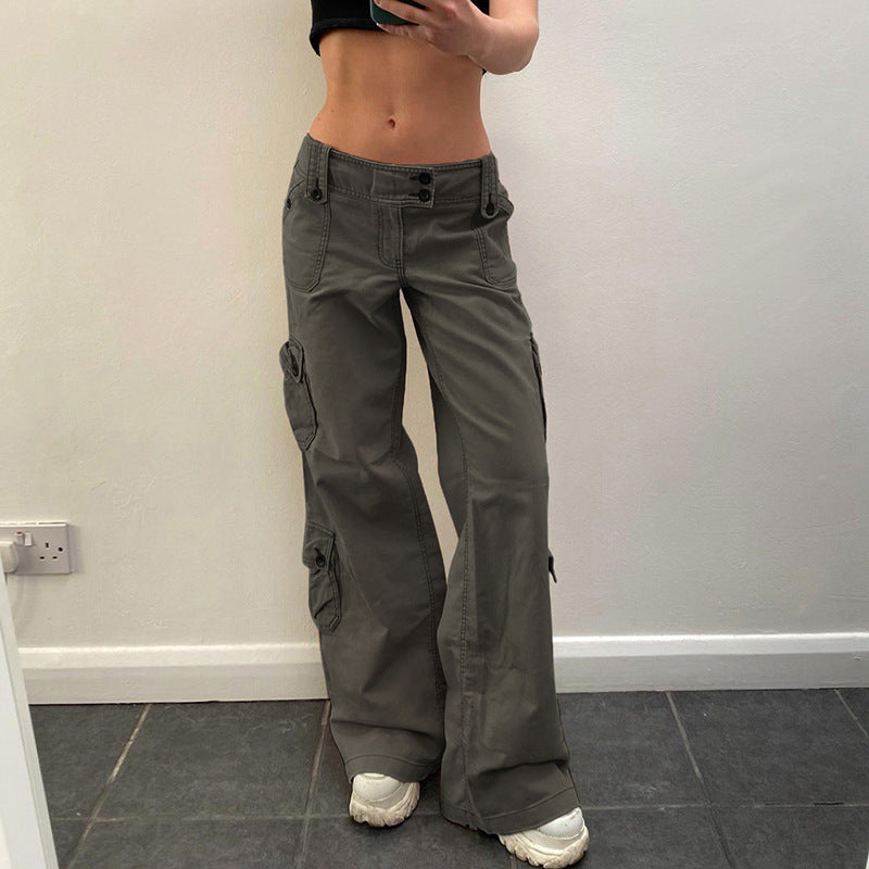 a woman wearing a black top and grey pants