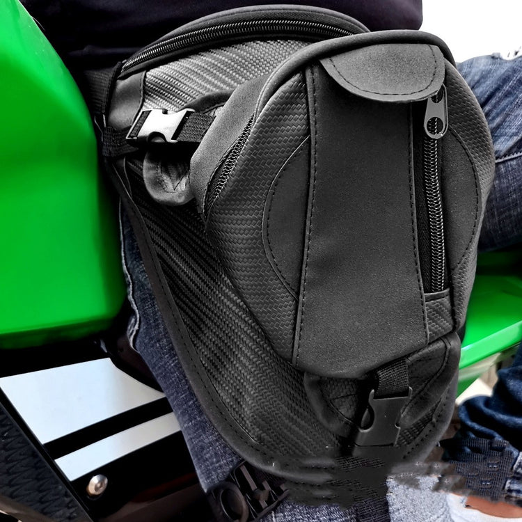 a black backpack on a green and black motorcycle