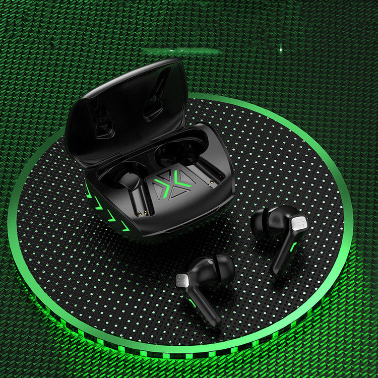 a black box with a green x and earbuds on a black surface