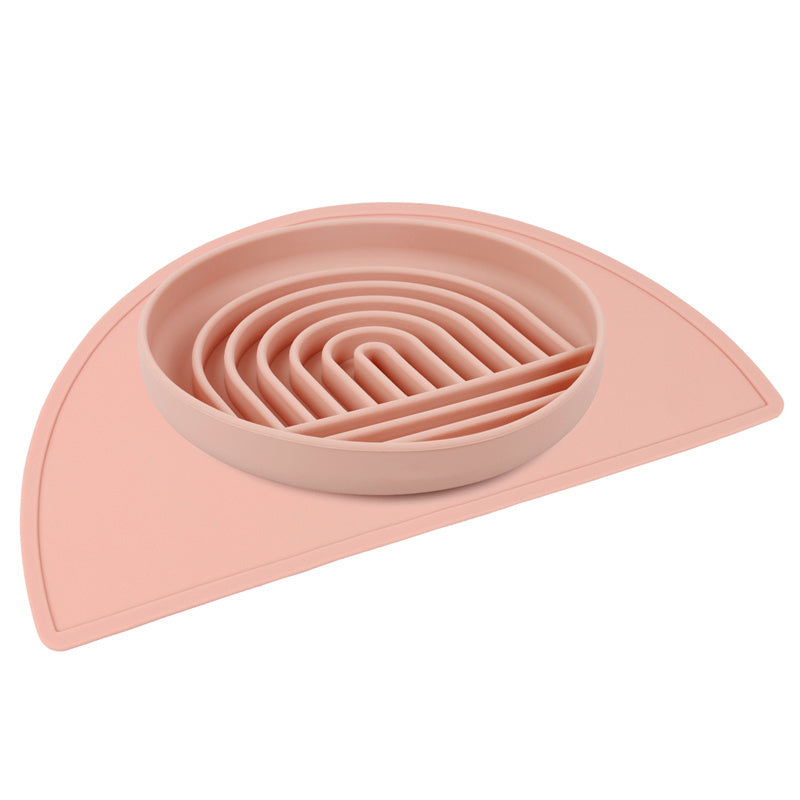 a pink bowl with spirals on a pink mat