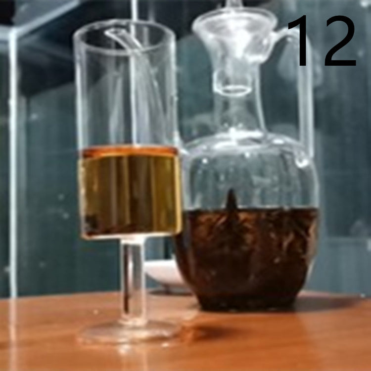 a glass with a straw next to a glass with brown liquid